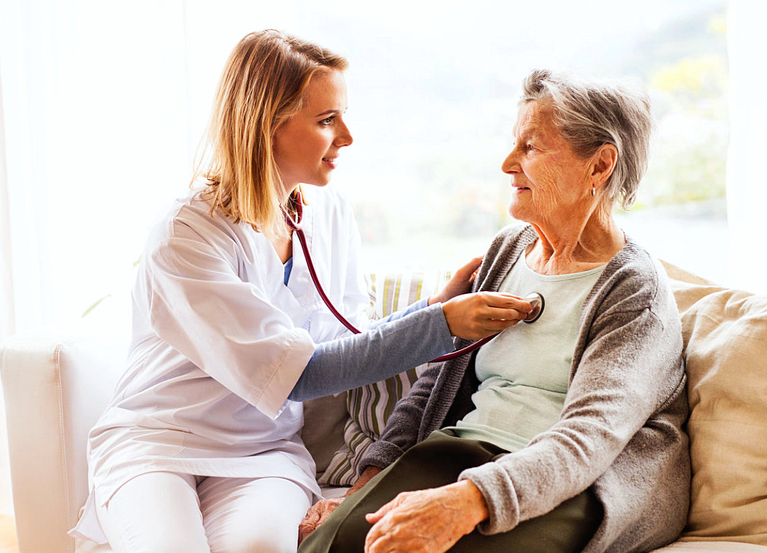 registered nurse checking senior womans health